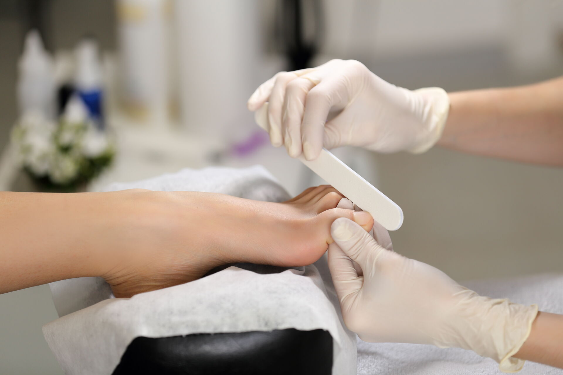 Gesunder Fuß bei der medizinischen Fußpflege - die Fußnägel werden mit einer Feile bearbeitet.